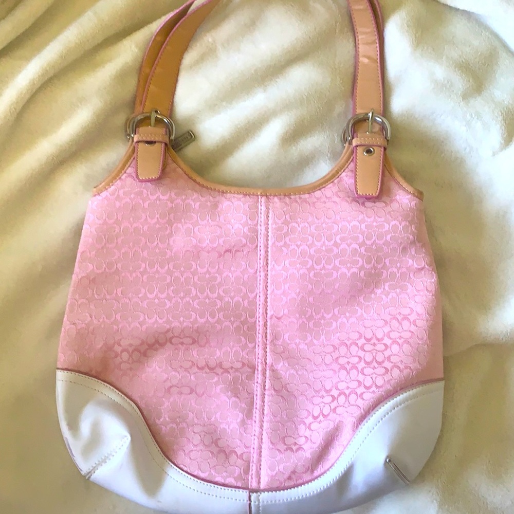 A pink and white coach purse